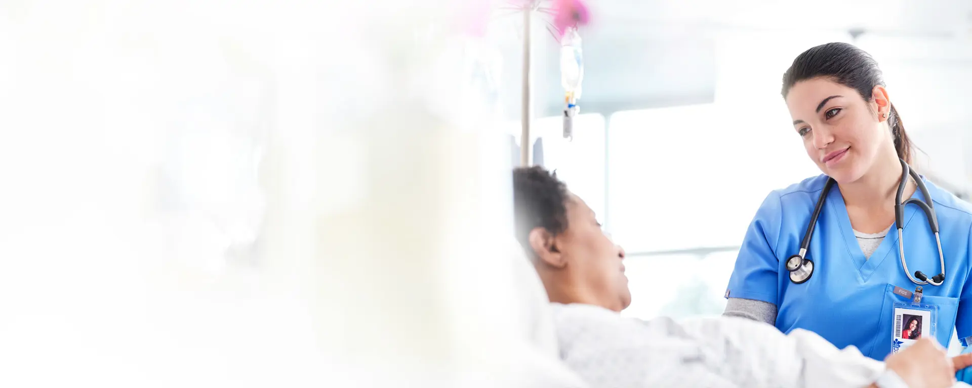 nurse with patient in hospital room