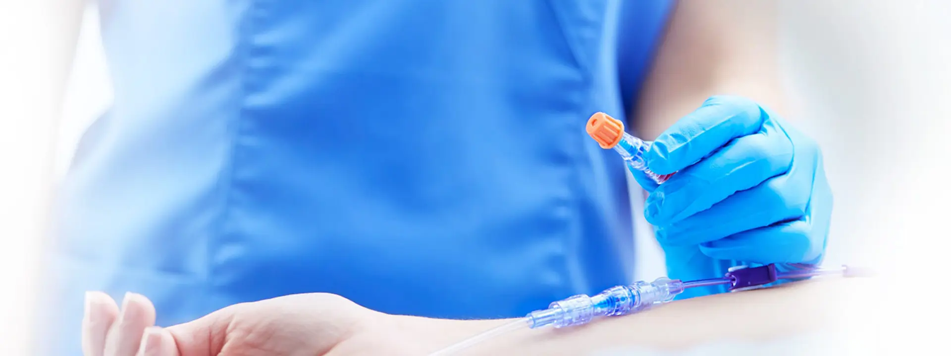 Closeup of nurse using disinfecting cap.